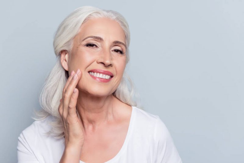 Woman touching her smooth face