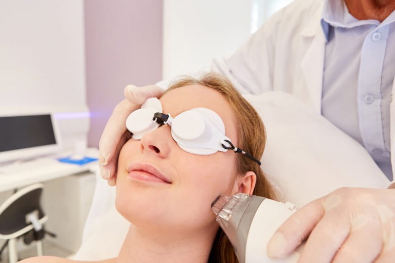 Woman having laser face procedure