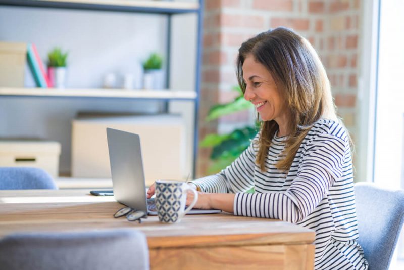 Smiling woman working on a laptop